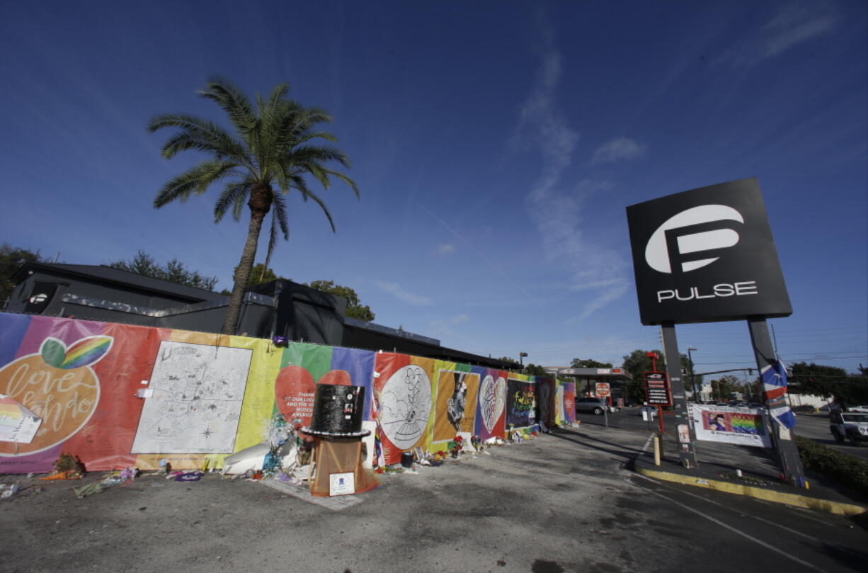 Artwork and signatures cover a fence around the Pulse nightclub, scene of a mass shooting, in Orlando, Fla. Jurors in the federal trial of Noor Salman, the Pulse nightclub gunman’s widow, have gotten a look inside his Florida condo through crime scene photos taken as FBI agents searched the home. They also saw some of her husband Omar Mateen’s web browsing history Tuesday, March 20, 2018, including beheading videos created by the Islamic State group Mateen had pledged allegiance to. Salman is accused of aiding and abetting her husband in the 2016 attack that left 49 people dead.