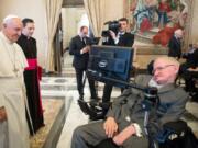 Pope Francis greets physicist Stephen Hawking on Nov. 28, 2016 during an audience with participants at a plenary session of the Pontifical Academy of Sciences, at the Vatican.