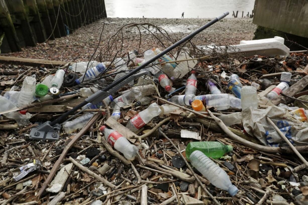 Plastic bottles and other plastics including a mop, lie washed up on the foreshore at the site of the ancient and no-longer used Queenhithe dock, a designated scheduled monument which dates back to at least the time of King Alfred the Great who lived from 849 to 899 AD, on the north bank of the River Thames in London, Monday, Feb. 5, 2018. Amid growing evidence of dire amounts of waste in the world’s oceans, conservation is becoming a selling point for firms trying to jump on the bandwagon of concern about the flood of plastic choking sea life.