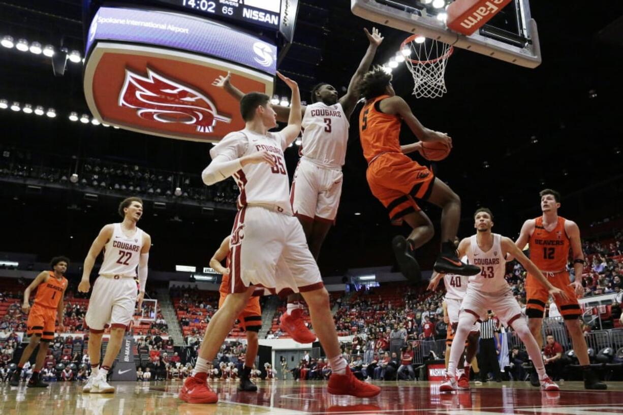 Oregon State guard Ethan Thompson (5) shoots next to Washington State forward Robert Franks (3) during the second half of an NCAA college basketball game in Pullman, Wash., Saturday, March 3, 2018.