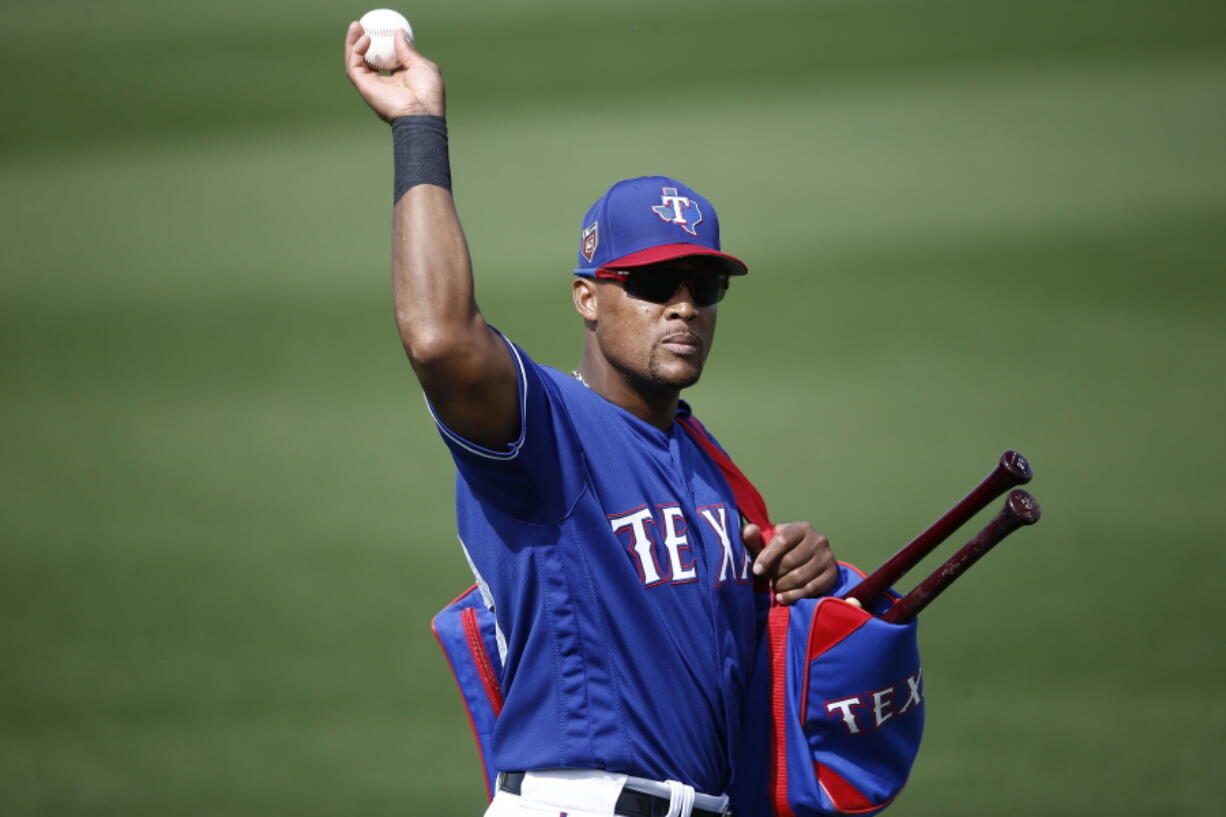 Texas Rangers third baseman Adrian Beltre tosses a baseball to a fan during the fifth inning of the team’s spring training baseball game against the Chicago White Sox on Thursday, March 8, 2018, in Surprise, Ariz. Going into his 21st big-league season, Beltre is one of only two current players who have played at least 20 MLB seasons. (AP Photo/Ross D.