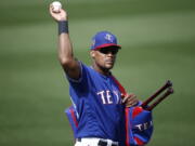 Texas Rangers third baseman Adrian Beltre tosses a baseball to a fan during the fifth inning of the team’s spring training baseball game against the Chicago White Sox on Thursday, March 8, 2018, in Surprise, Ariz. Going into his 21st big-league season, Beltre is one of only two current players who have played at least 20 MLB seasons. (AP Photo/Ross D.