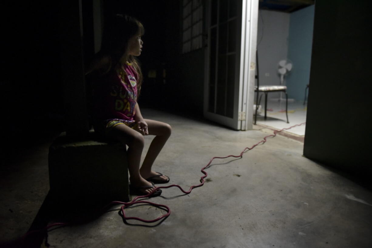 Six-year-old Melanie Oliveras González remains seated on the balcony of her house, in Barrio Patrón, Morovis, Puerto Rico. Justo Gonzalez, interim director for Puerto Rico’s Electric Power Authority, said he expects the entire island to have power by May 2018, eight months after the Category 4 storm destroyed two-thirds of the island’s power distribution system and just as the 2018 hurricane season is about to start.