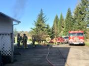 Firefighters work at the scene of a Ridgefield house fire Tuesday morning. The Clark County Fire Marshal is investigating the cause.