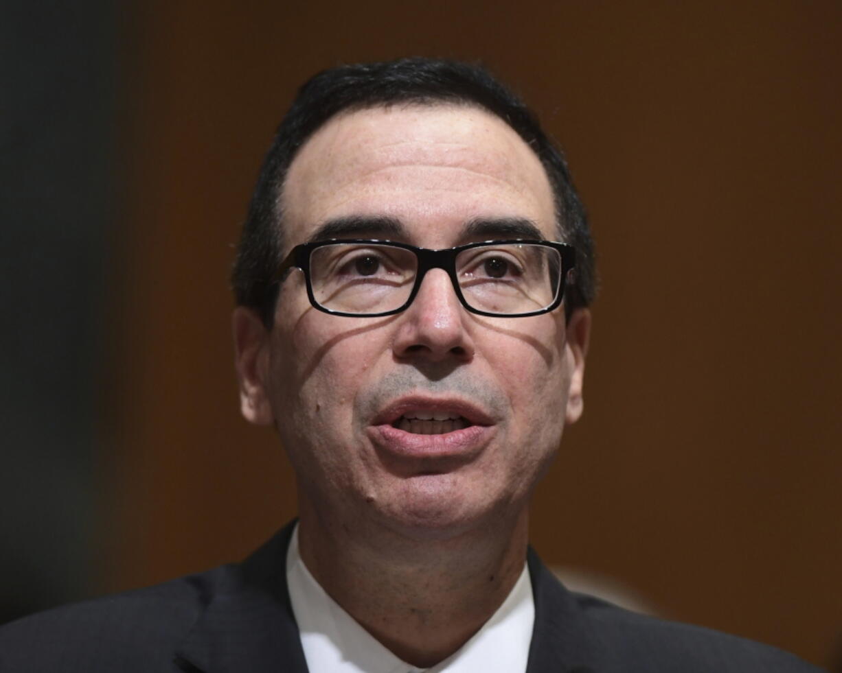 In this Feb. 14, 2018 photo, Treasury Secretary Steven Mnuchin testifies before the Senate Finance Committee on Capitol Hill in Washington. The Trump administration accused Russia on Thursday of a concerted, ongoing operation to hack and spy on the U.S. energy grid and other critical infrastructure.