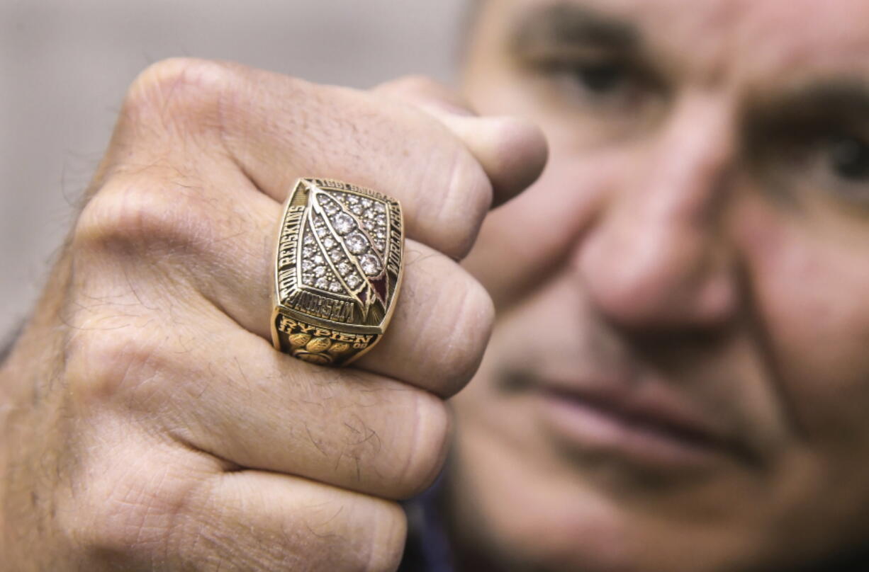 Former Super Bowl MVP Mark Rypien displays his Super Bowl ring in Spokane. Rypien said he has attempted suicide, hired prostitutes and suffers from persistent depression, and wonders if he suffered brain injuries while playing football.