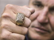 Former Super Bowl MVP Mark Rypien displays his Super Bowl ring in Spokane. Rypien said he has attempted suicide, hired prostitutes and suffers from persistent depression, and wonders if he suffered brain injuries while playing football.