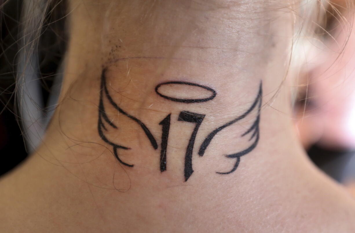 Rio Gonzales, 17, a Coral Springs High School student, shows a tattoo she got in Coral Springs, Fla., to honor the students who were killed in the mass shooting at Marjory Stoneman Douglas High School. Gonzales and hundreds of other members of the community participated in the donation-based fundraiser sponsored by No Hard Feelings Tattoo Gallery in Coral Springs. The tattoo shop along with nine other tattoo artists and body piercers, offered a day of free tattoos to the community with donations going toward the families and victims of the Marjory Stoneman Douglas shooting.