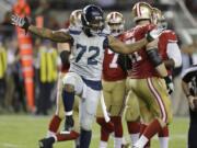 FILE - In this Oct. 22, 2015, file photo, Seattle Seahawks defensive end Michael Bennett (72) reacts after sacking San Francisco 49ers quarterback Colin Kaepernick during the second half of an NFL football game in Santa Clara, Calif. The Super Bowl champion Philadelphia Eagles have acquired three-time Pro Bowl defensive end Michael Bennett from the Seattle Seahawks, two people familiar with the trade told The Associated Press Wednesday, March 7, 2018.