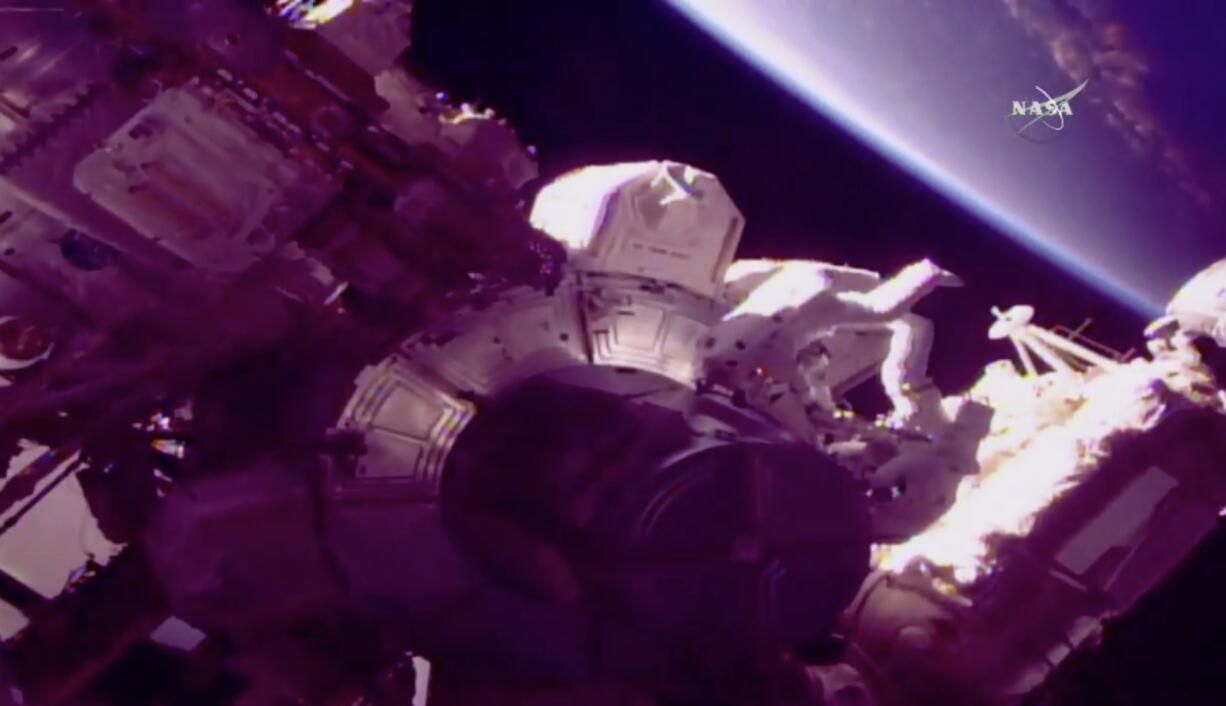 Astronaut Drew Feustel, right, and NASA astronaut Ricky Arnold prepare to install new antennas, replace a bad camera and remove jumper cables from a leaky radiator at the International Space Station Thursday, March 29, 2018.