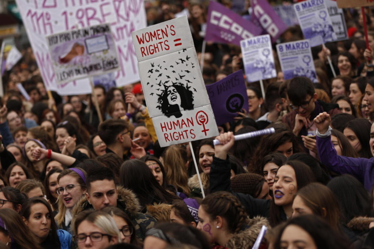 People, mostly women, shout slogans during a protest at the Sol square during the International Women’s Day in Madrid, Thursday, March 8, 2018. Spanish women are marking International Women’s Day with the first-ever full day strike and dozens of protests across the country against wage gap and gender violence.