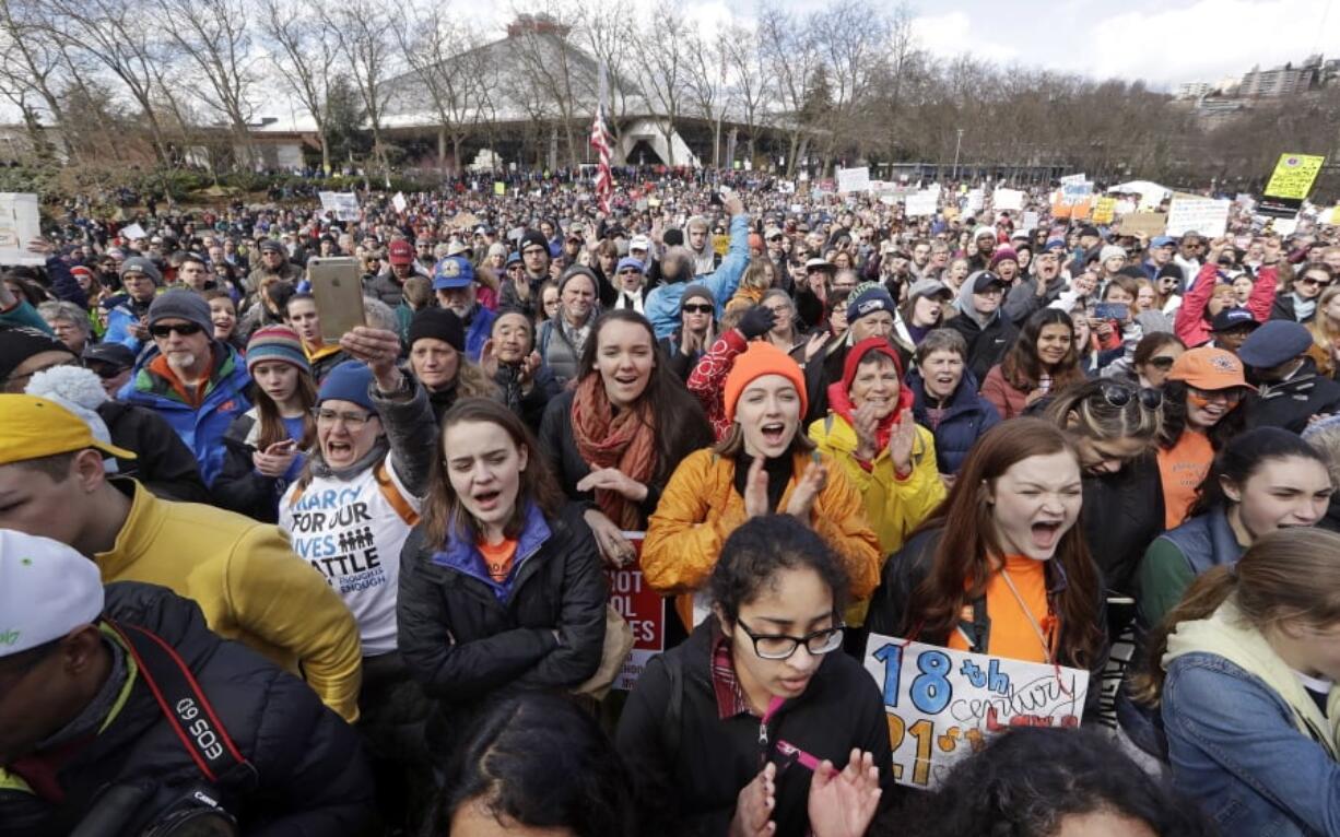 Thousands of protesters cheer at a rally following a march in favor of gun control at the Seattle Center Saturday, March 24, 2018, in Seattle. Summoned to action by student survivors of the Florida school shooting, hundreds of thousands of teenagers and their supporters rallied in the nation’s capital and cities across America on Saturday to press for gun control in one of the biggest youth protests since the Vietnam era.