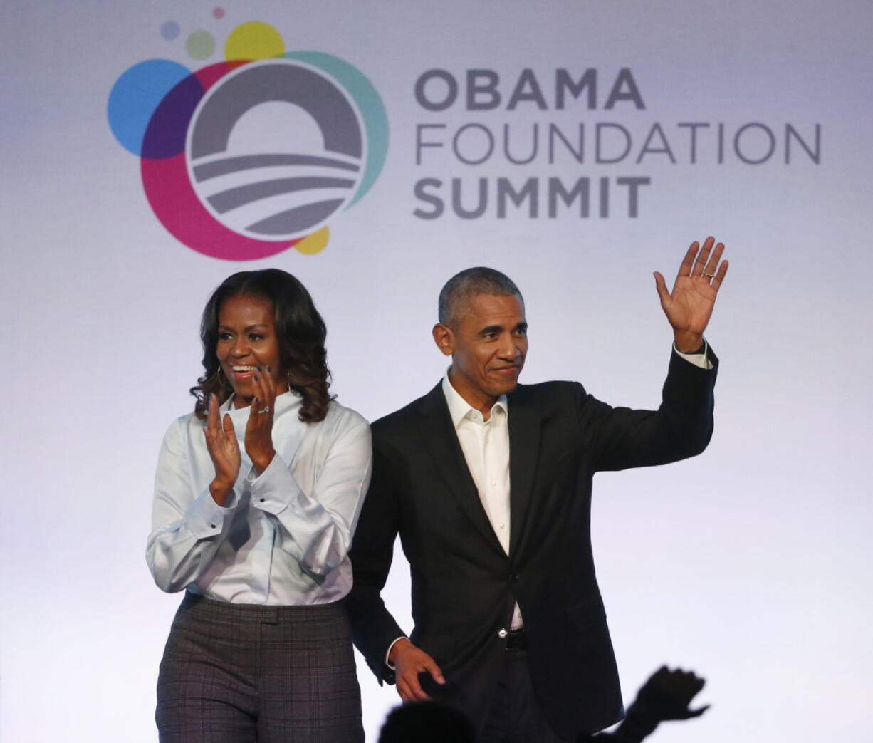 Former President Barack Obama, right, and former first lady Michelle Obama arrive for the first session of the Obama Foundation Summit in Chicago.