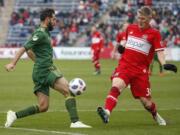 Portland Timbers midfielder Diego Valeri, left, battles for the ball with Chicago Fire midfielder Bastian Schweinsteiger, right, during the first half of an MLS soccer match, Saturday, March 31, 2018, in Bridgeview, Ill.