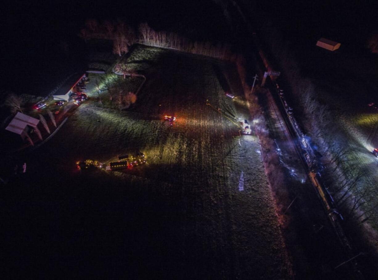 The scene where two trains, right, collided and derailed in Georgetown, Ky., early Monday. Four people were injured after the accident late Sunday night.