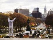 Alex Carrillo Quito of Ecuador imitates the character Rocky Balboa from the 1976 movie “Rocky,” on the steps of the Philadelphia Museum of Art, in Philadelphia.