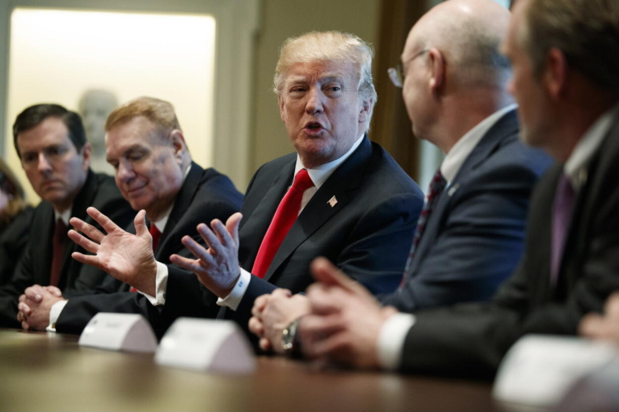 President Donald Trump speaks during a meeting with steel and aluminum executives in the Cabinet Room of the White House on Thursday in Washington. From left, Roger Newport of AK Steel, John Ferriola of Nucor, Trump, Dave Burritt of U.S. Steel Corporation, and Tim Timken of Timken Steel.