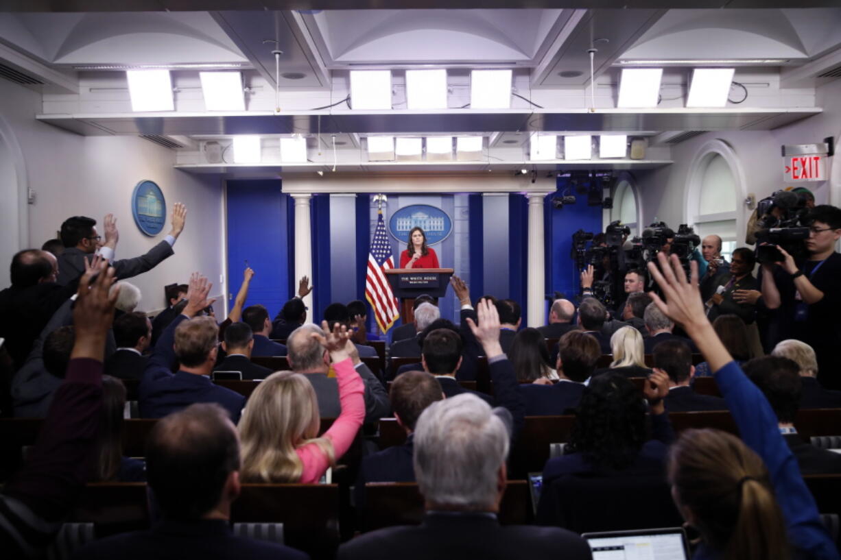 Reporters raise their hands to ask a question of White House press secretary Sarah Huckabee Sanders during the daily press briefing at the White House on Wednesday in Washington.