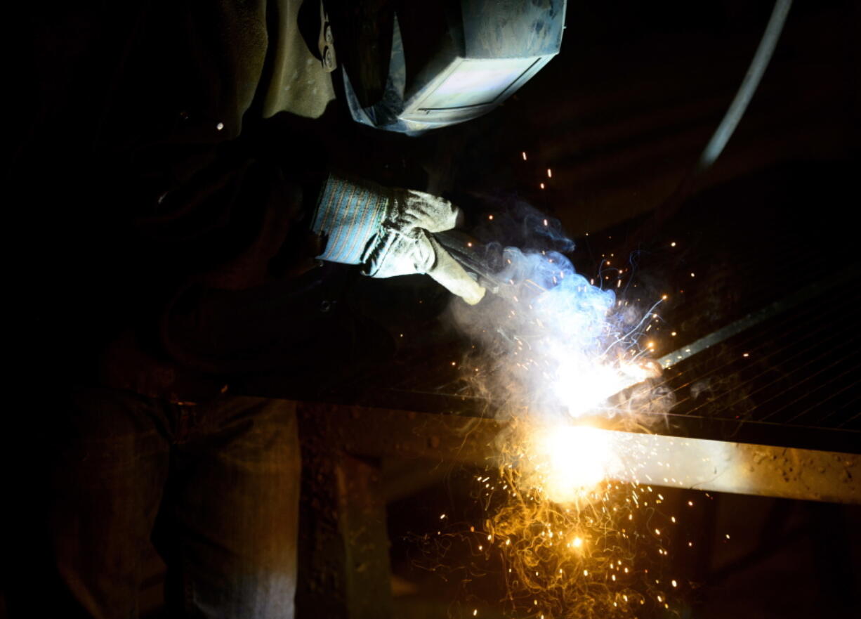 A welder fabricates a steel structure at an iron works facility in Ottawa, Ontario, on Monday. President Donald Trump insisted Monday that he’s “not backing down” on his plan to impose stiff tariffs on imported steel and aluminum despite anxious warnings from House Speaker Paul Ryan and other congressional Republicans of a possible trade war.