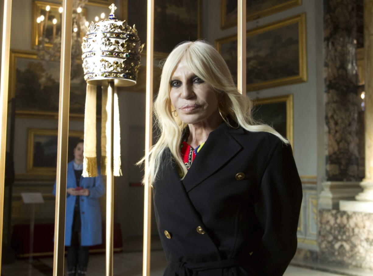 Donatella Versace poses next to one of the Tiara (1877) of pope Pius IX in Rome, Monday, Feb. 26, 2018. The Vatican is loaning some of its most beautiful liturgical vestments, jeweled miter caps and historic papal tiaras for an upcoming exhibit on Catholic influences in fashion at the Metropolitan Museum of Art. The Vatican culture minister, Cardinal Gianfranco Ravasi, joined Vogue Editor-in-Chief Anna Wintour and designer Donatella Versace in Rome on Monday to display a few of the Vatican treasures at the Palazzo Colonna, a onetime papal residence. “Heavenly Bodies: Fashion and the Catholic Imagination” is set to open May 10 at the Met’s Costume Institute in New York.