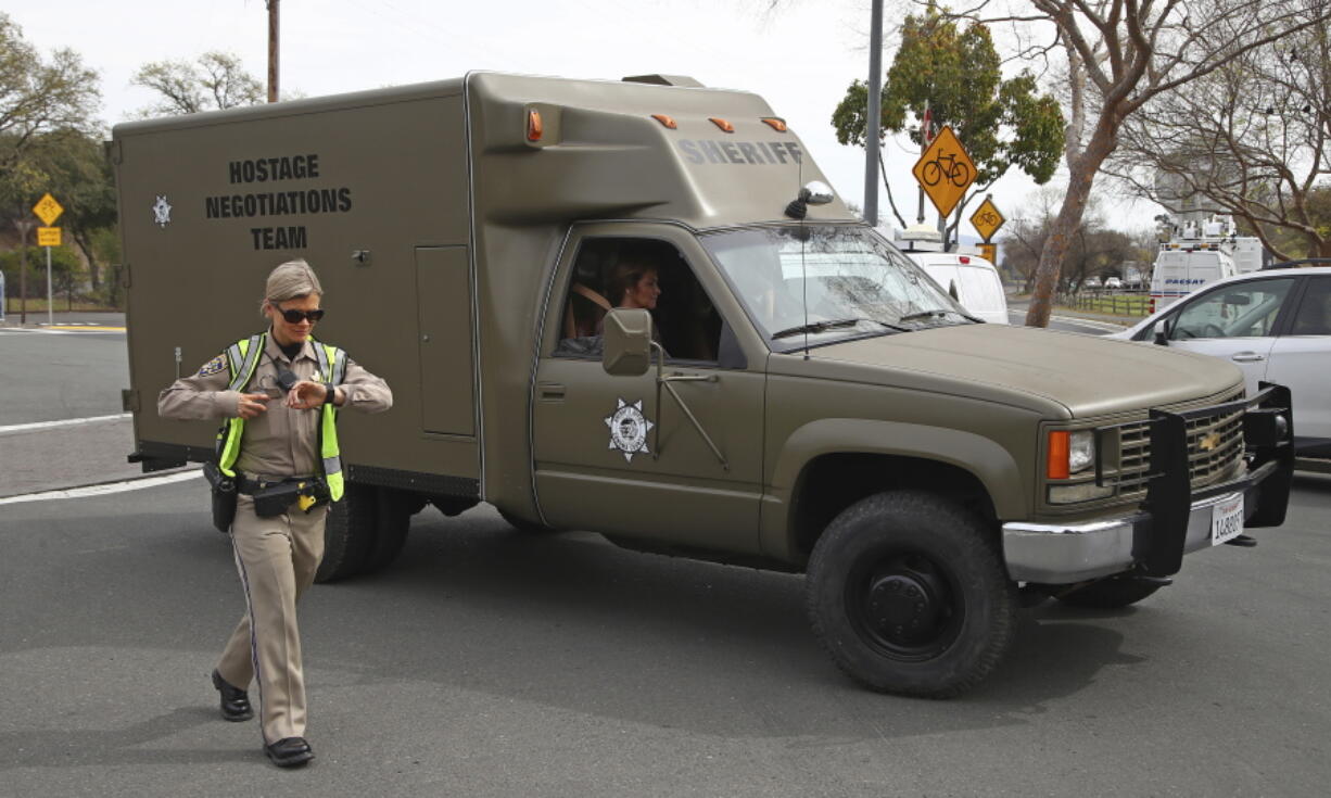 A sheriff’s hostage negotiation team passes a California highway patrol checkpoint at the Veterans Home of California in Yountville, Calif., Friday, March 9, 2018. Napa County Fire Capt. Chase Beckman says a gunman has taken hostages at the veterans home. Police closed access to the large veterans home after a man with a gun was reported on the grounds.