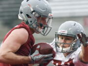 Washington State wide receiver Kyle Sweet, left, catches a pass as Jonathan Jun defends during the NCAA college football team's spring practice Thursday, March 22, 2018, in Pullman, Wash.