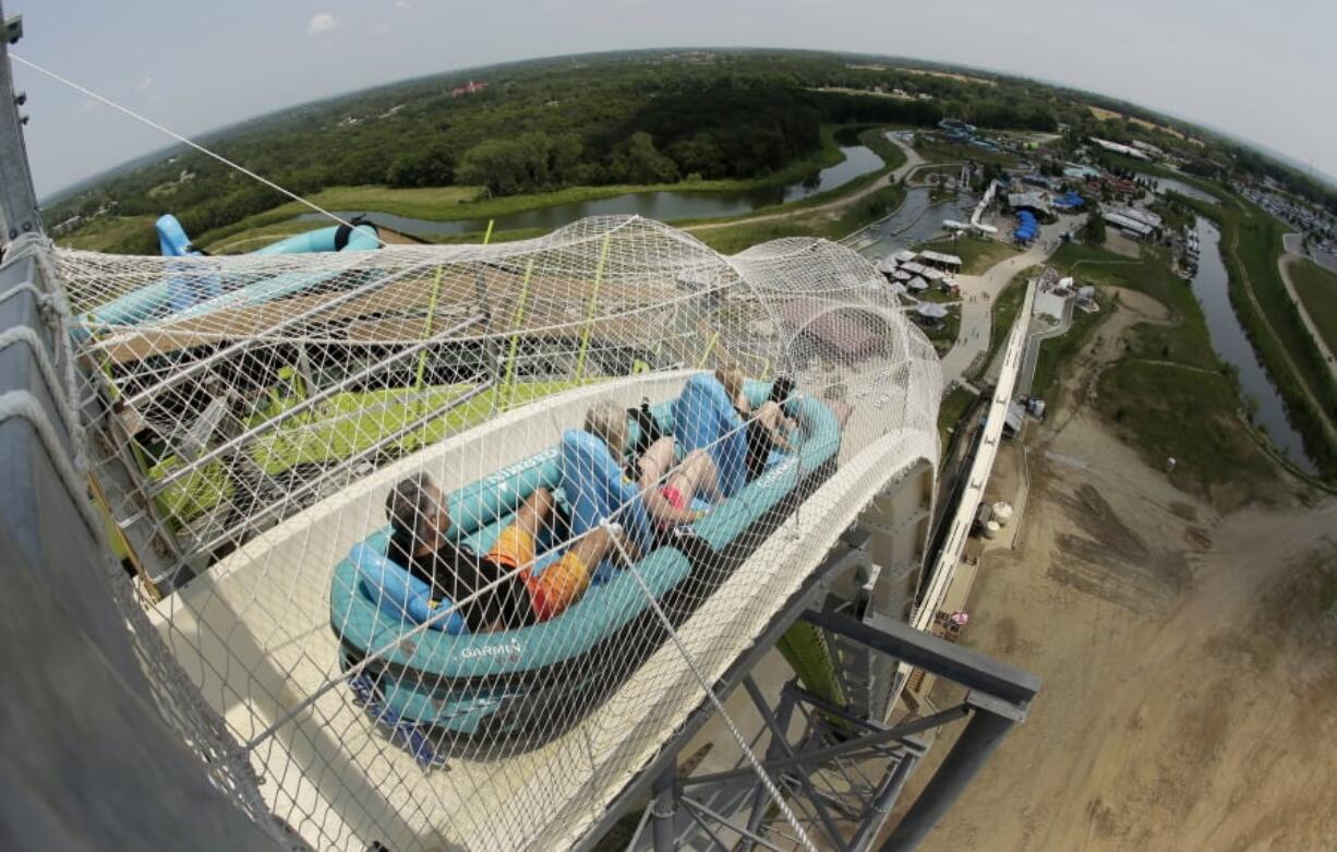 FILE - In this July 9, 2014, file photo, riders go down the water slide called “Verruckt” at Schlitterbahn Waterpark in Kansas City, Kan. A former executive with the Kansas water park where a 10-year-old boy died on the giant waterslide has been charged with involuntary manslaughter. Tyler Austin Miles, an operations director for Schlitterbahn, was booked into the Wyandotte County jail Friday, March 23, 2018 and is being held on $50,000 bond. Caleb Schwab died in August 2016 on the 17-story Verruckt water slide at the park in western Kansas City, Kansas.