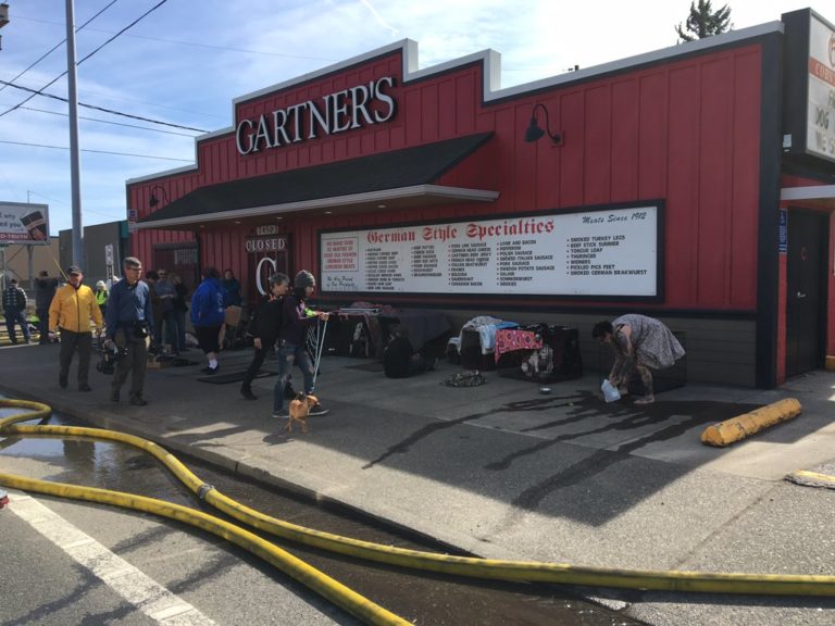 People and pets shelter in the share of Gartner's Meat Market on Killingsworth in Portland after evacuating from their homes due to a large fire that started in a scrap yard in Northeast Portland. (Portland Fire and Rescue)