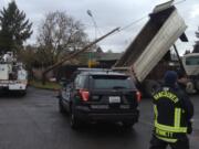 Vancouver firefighters and police responded to a downed power pole Thursday morning after a dump truck came into contact with a powerline, causing damage to the attached pole on the corner of Northeast 82nd Avenue and Northeast 7th Street.