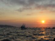 The sun sets upon anglers at the mouth of the Columbia River last summer. Poor returns mean fishermen are facing steep reductions in opportunities for fall salmon and summer steelhead this year. Fisheries along Washington’s coast and in the Columbia River will be affected.