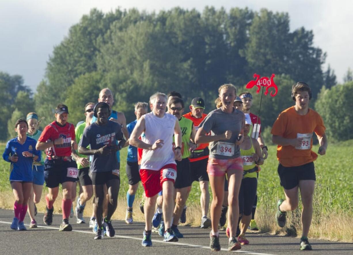 Runners take part in the Vancouver USA Marathon near Vancouver Lake on June 19, 2016. The 2017 Vancouver USA Marathon was canceled about a month before the race, prompting a proposed class-action lawsuit in federal court over registration fees.