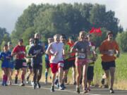 Runners take part in the Vancouver USA Marathon near Vancouver Lake on June 19, 2016. The 2017 Vancouver USA Marathon was canceled about a month before the race, prompting a proposed class-action lawsuit in federal court over registration fees.