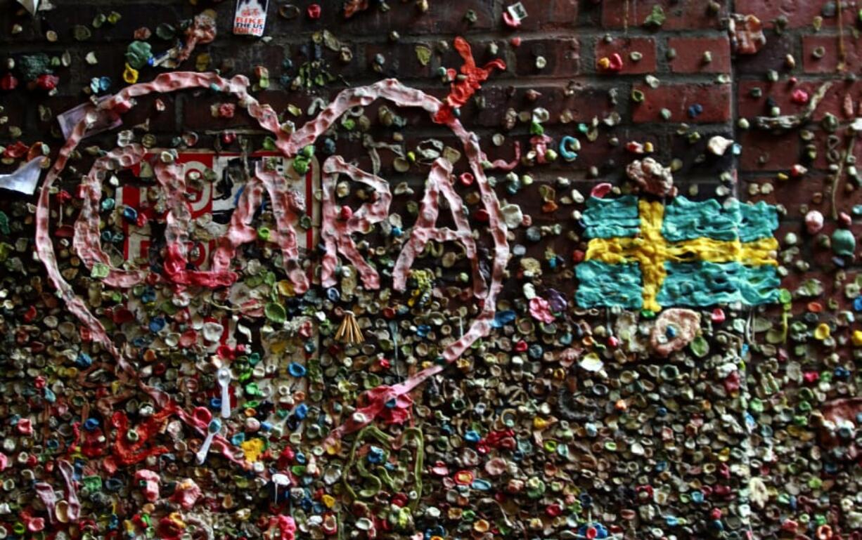 Displays left in gum include a Swedish flag and a heart containing the name Clara. An estimated 750,000 gum wads are on the wall in Seattle.