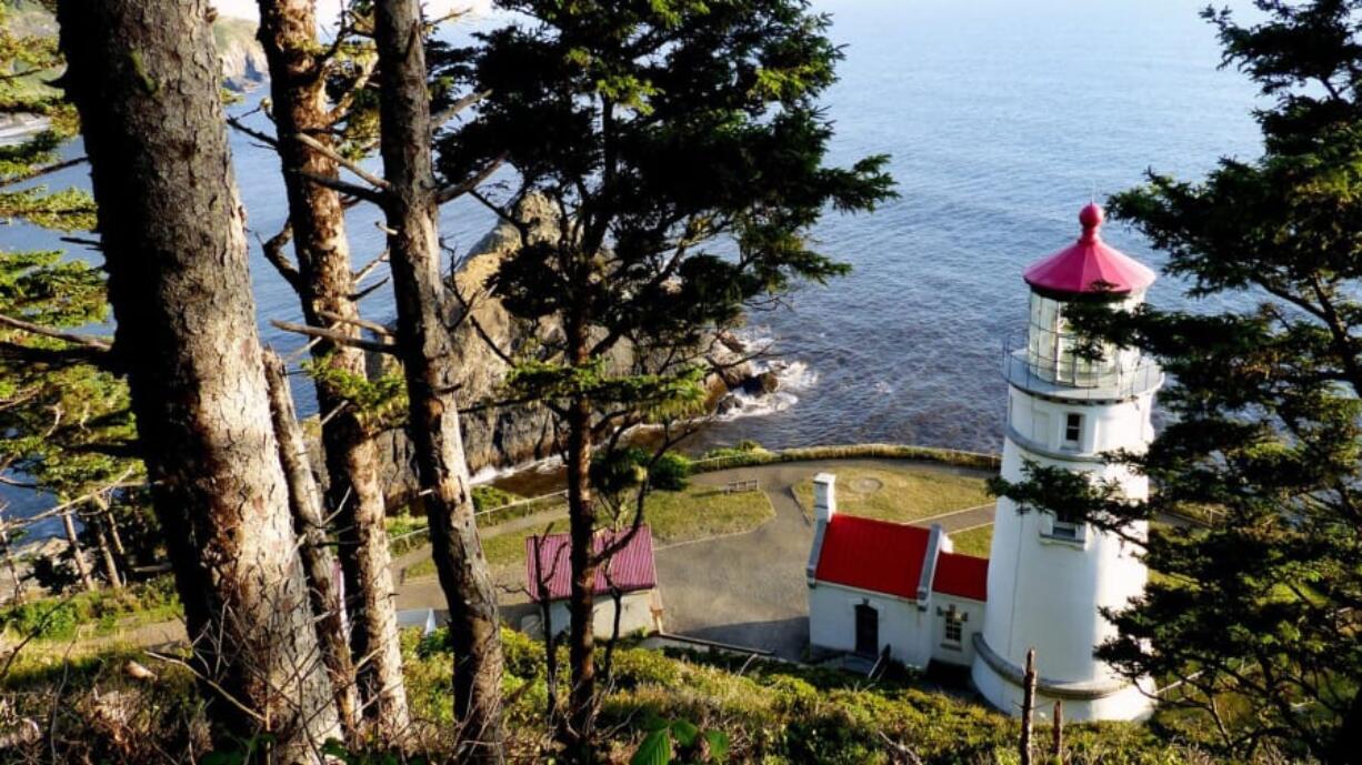 Hiking trails offer peekaboo views from above the Heceta Head Lighthouse in Yachats, Ore. Brian J.