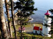 Hiking trails offer peekaboo views from above the Heceta Head Lighthouse in Yachats, Ore. Brian J.