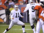 Oakland kicker Sebastian Janikowski (11) celebrates with holder Shane Lechler (9) after kicking a 63-yard field goal in 2011. Janikowski will compete for the kicking job with the Seattle Seahawks in 2018, having signed with the team on Friday, April 13, 2018.