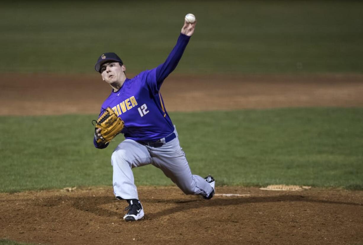 Columbia River's Nick Nygard (12) pitches during Friday night's game at Propstra Stadium in Vancouver on March 9, 2018. Columbia River won the season-opener 8-2.