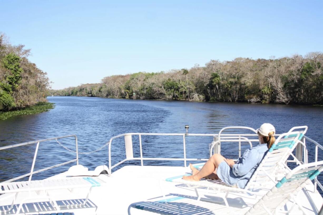 The top deck of a houseboat is a good spot to relax and take in the view of the St. Johns River.