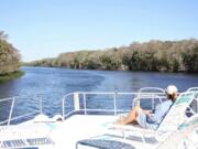 The top deck of a houseboat is a good spot to relax and take in the view of the St. Johns River.