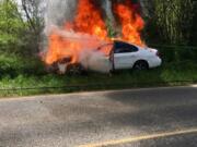 A car burns after crashing into a power pole Sunday afternoon near Battle Ground. No injuries were reported, but a few hundred customers were without power for a time following the crash.