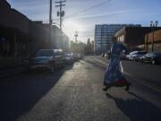 Keegan Dittmer, 17, runs back toward Renegades Bar and Grill in kimono and sky-high heels after retrieving items from his car in order to take part in a Sunday night drag show.