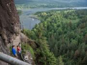 Hikers ascend the century-old stairway trail at Beacon Rock State Park.