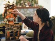 Jackie Shepherd, 19, sets up a kabuto decoration, a traditional samurai suit of armor displayed annually in many Japanese homes to celebrate Children’s Day, at her home in Vancouver. As a child, Shepherd would help set up the kabuto with her family. It has become a special tradition that reminds her of her Japanese heritage. The former Clark College student received a scholarship to study in Japan for the next five years.