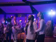 Pastor Daniel Fusco and his wife, Lynn, sing along with worship songs. Lynn Fusco is the women’s ministry director at Crossroads Community Church. “Our job is just to love people where they are and encourage them. It’s kind of a cool hodgepodge of humanity at Crossroads. It’s a beautiful thing,” Daniel Fusco said.