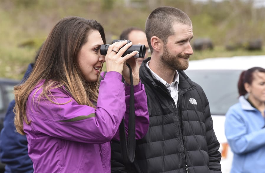 Rep. Jaime Herrera Beutler, R-Battle Ground, left, and Kyle Tidwell from the U.S. Army Corps of Engineers, look out at sea lions swimming in the Columbia River.