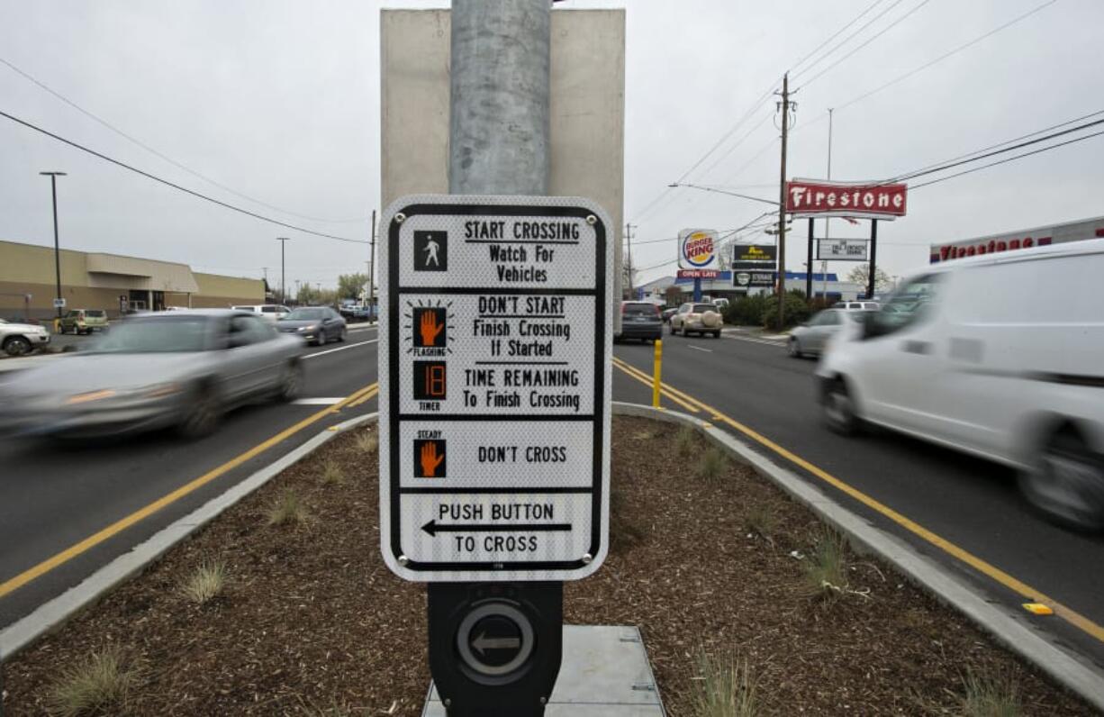 Traffic rushes past a median along Highway 99 in Hazel Dell.