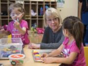 Sen. Patty Murray visits with Alivia Estrada-Houghton, left, and her twin Alayna, right, both 2 and of Vancouver, at the Hough Early Learning Center.