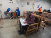 David La Buda works on paperwork at the day center at Friends of the Carpenter at 1600 W. 20th St. in Vancouver. La Buda is among several clients who plan to use a new day center planned for the former state Fish and Wildlife building at 2018 Grand Blvd. in Vancouver.