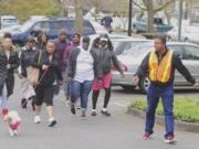Gerald Dory, right, leads a neighborhood walk during a Let’s Get Moving meeting. The program is a culture-specific program that takes aim at health disparities among black people.