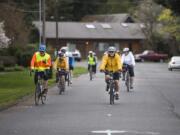 Steve Trinkle, left, and Tony Licata, right, lead a group of cyclists on a ride near McLoughlin Middle School. The Vancouver Bicycle Club is hosting Monday evening rides geared to people who want to get comfortable with road cycling but need guidance getting up to speed.